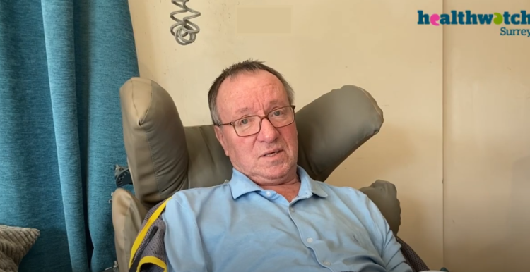 Man sitting in a high backed chair