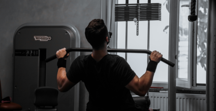 Photo of a man lifting a weight in a gym
