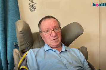 Man sitting in a high backed chair