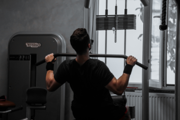Photo of a man lifting a weight in a gym