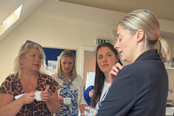 Four people having a discussion at the domestic abuse convening workshop.