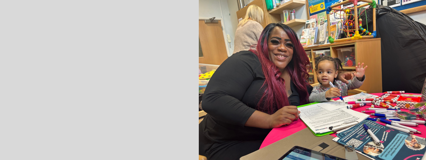 A mother and child sitting at our Healthwatch table at one of our engagement events.