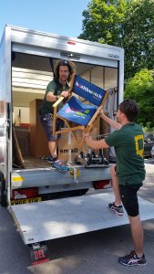 Picture of our magic movers from Anyvan lifting a chair out of the van.